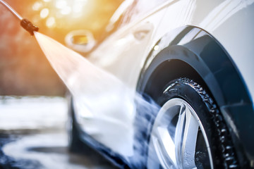 Wall Mural - Car wheel wash. Cleaning with water jet. Cars rim or alloy washing close up.