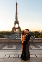 Romantic Couple Kisses Near The Eiffel Tower. Love, Date, Honeymoon In Paris