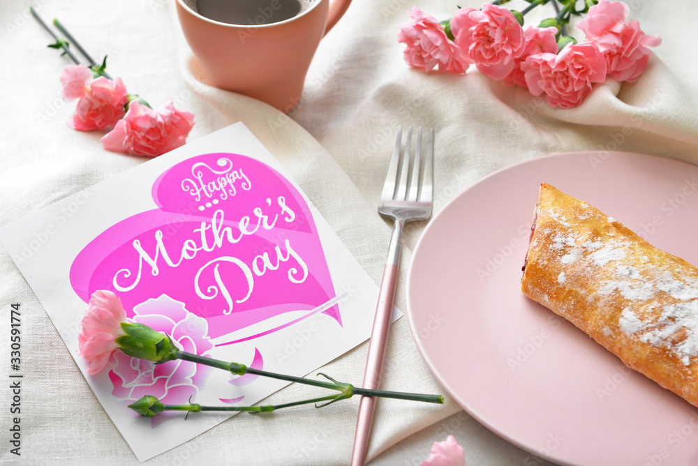 Card with text "Happy Mother's day" and tasty breakfast on table