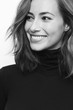 Portrait of young happy woman in black and white with a big smile on her face looking at one side
