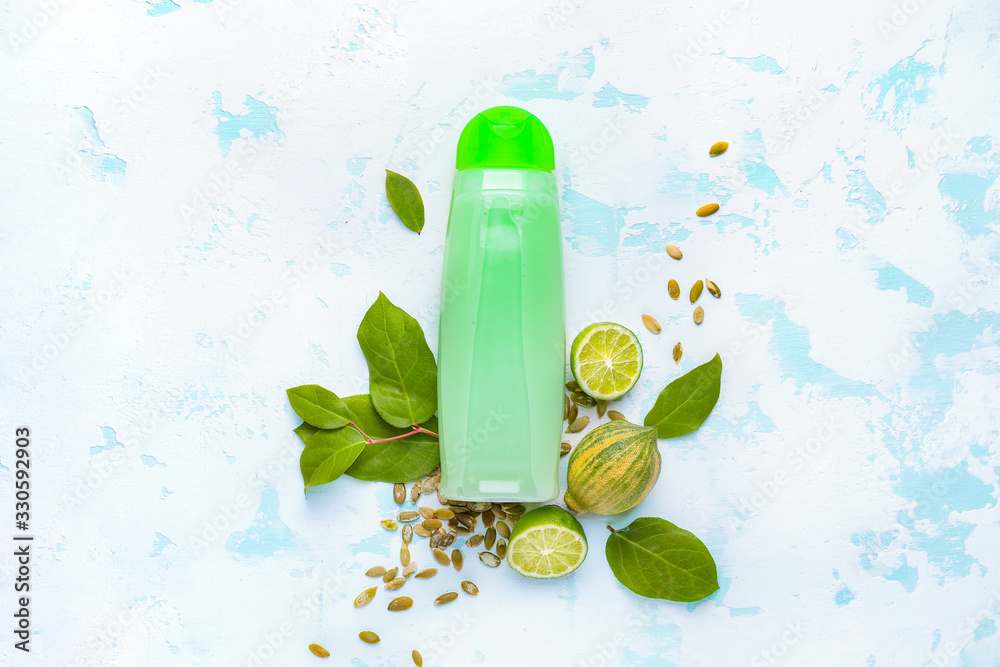 Composition with shampoo and natural ingredients on light background