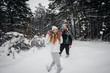 © Andrii - Couple playing with snow in the forest