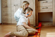 © irishasel - Children play at home, elder brother and curly cute baby girl play cars on the floor.