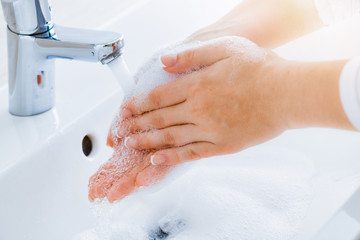 Wall Mural - Hygiene concept. Woman washing hands under the faucet with pure clear water.