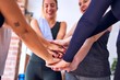 © Krakenimages.com - Young beautiful group of sportswomen smiling happy. Standing with hands together with smile on face after class of yoga at gym