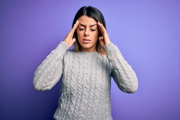 Poster - Young beautiful woman wearing casual sweater standing over isolated purple background with hand on head for pain in head because stress. Suffering migraine.