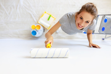 Wall Mural - Repair in apartment. Happy young woman paints wall .