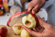 © Kristina Blokhin - Macro closeup of wooden chopping cutting board and person hands peeling old red apples fruit after harvest for cooking ingredient