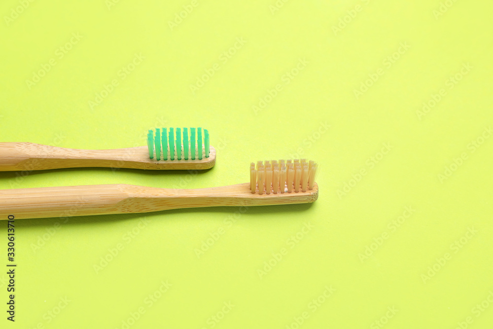 Wooden tooth brushes on color background