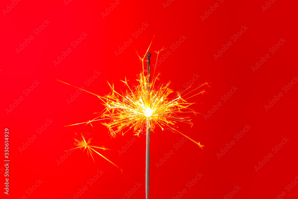 Beautiful Christmas sparkler on color background