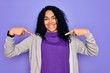 © Krakenimages.com - Young african american sporty woman wearing casual sweatshirt over purple background looking confident with smile on face, pointing oneself with fingers proud and happy.