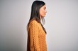 © Krakenimages.com - Young beautiful brunette woman wearing casual sweater over isolated white background looking to side, relax profile pose with natural face and confident smile.