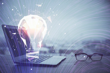 Poster - Computer on desktop in office with bulb icon hologram. Multi exposure. Concept of idea.