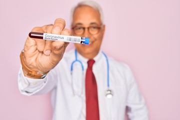 Poster - Middle age senior doctor holding medice blood sample of coronavirus infection disease with a happy face standing and smiling with a confident smile showing teeth