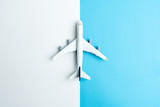 Fototapeta  - Flat lay miniature airplane model isolated on white and blue background