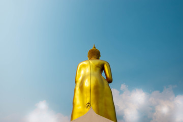 The back of the golden Buddha and the bright sky