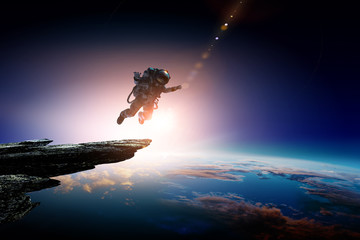 Wall Mural - spaceman and planet, human in space concept