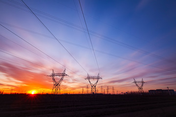 In the evening, the high voltage tower and the beautiful sunset glow