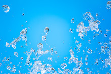 Splashes Of Water Against The Blue Sky Background