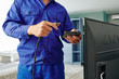 © DragonImages - Electrician connecting digital tv receiver with tv set