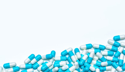 Wall Mural - Pile of antibiotic capsule pills isolated on white background. Global market trends of antimicrobial drugs concept. Antibiotic drug resistance. Pharmaceutical industry. Pharmacy drugstore products.