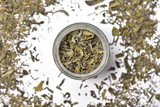 Fototapeta Mapy - Green Dry Tea Leaves in Jar on white background 