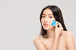 Beautiful Attractive Asian woman using Facial oil clean film to removal oily on face for face fresh skin feeling so fresh and clean,Beauty Concept,Isolated on grey background