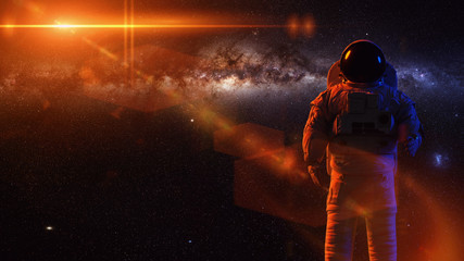 Canvas Print - standing astronaut in front of the milky way galaxy