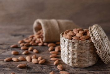 Almond in basket on blurred wooden background