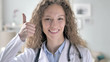 © stockbakers - Thumbs Up by Young Lady Doctor in Clinic