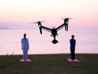 drone shooting when 2 people doing yoga at morning time