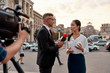 © Svitlana - Professional reporter interviewing woman on urban street. Journalism industry, live streaming concept