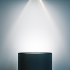 empty illuminated pedestal in interior with copy space.
