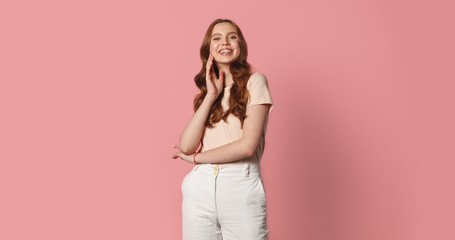 young smiling caucasian woman posing isolated on pink background