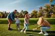 © Svitlana - Where children grow in mind and spirit. Excited family having fun outdoors on a sunny day