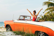 Sexy Woman In Red Swimsuit And Retro Cabriolet Car
