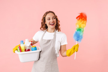 Canvas Print - Optimistic young housewife holding cleanser bottles