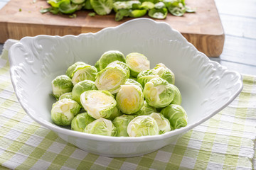 Wall Mural - Fresh brusseles sprouts in bowl on kitchen table