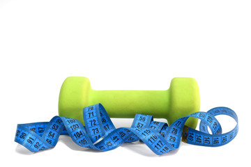 Green dumbbell with measuring tape on a white background