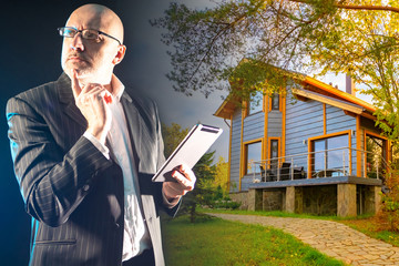 Poster - a man holds an electronic tablet against the background of a wooden cottage. a person reflects on th