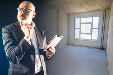 Poster - Interior designer in a new building. A man is developing a project for finishing an apartment. Design project of new housing. Repairing flat.