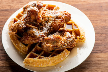 Chicken & waffles. Classic American Diner Style Breakfast or Brunch menu item favorite. Crispy homemade fried chicken on top of home buttermilk waffles topped with butter and maple syrup. 