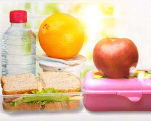 Poster - Lunch box with sandwiches, fruits and water on the desk