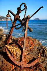 Wall Mural - Alassio (SV), Italy - February 15, 2017: An old anchor at Alassio beach, Riviera dei Fiori, Savona, Liguria, Italy.