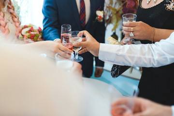 Wall Mural - couple clanging glasses with guests