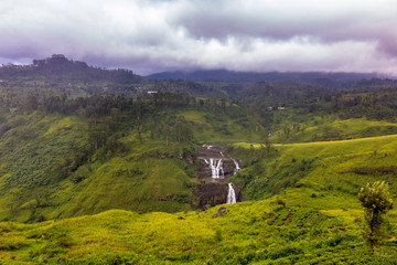 Wall Mural - Waterfall in several stages in a beautiful green valley on Sri Lanka