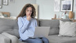 © stockbakers - Wondering Pensive Curly Hair Woman working on Laptop
