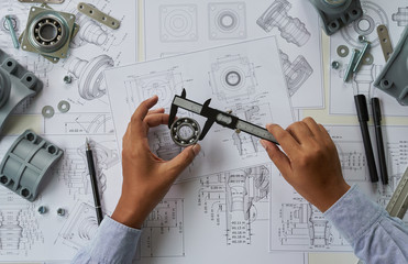 Poster - Engineer technician designing drawings mechanical parts engineering Engine.manufacturing factory Industry Industrial work project blueprints measuring bearings caliper tools
