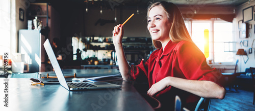 Fotomural Young and smiling woman working with laptop in the morning in big spacious room