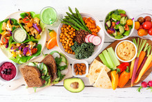Healthy Lunch Table Scene With Nutritious Lettuce Wraps, Buddha Bowl, Vegetables, Sandwiches, And Salad. Overhead View Over A White Wood Background.